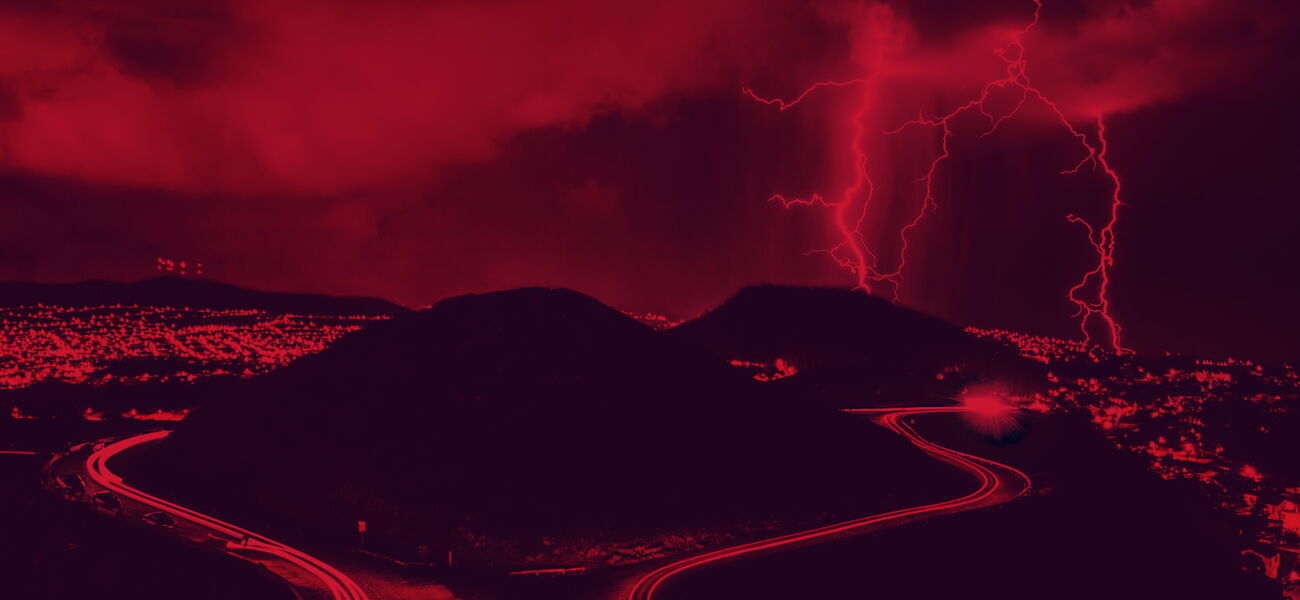 Reddish image - A landscape with mountains and three large lightning bolts.