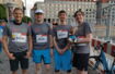 Team Challenge 2022 - Four men stand in the city center, ready for a run.
